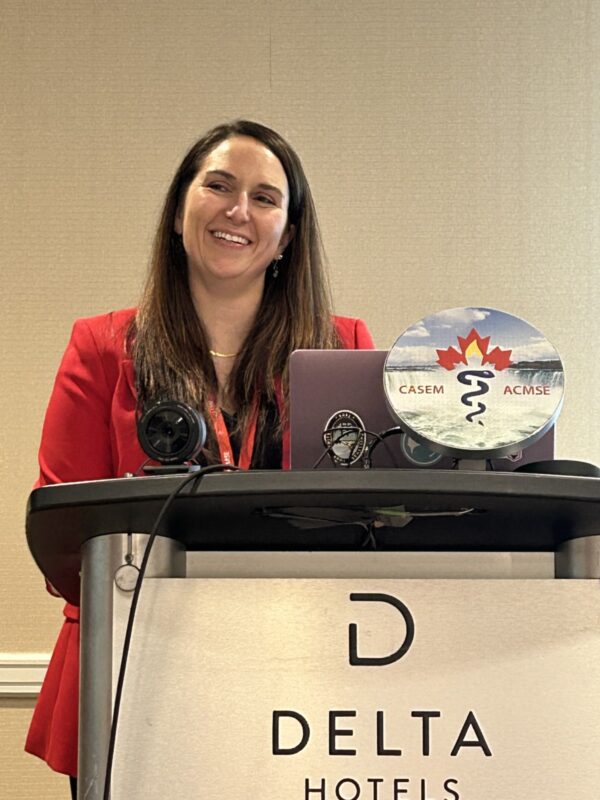 Dr Stephanie Melanson Speaking at a Podium